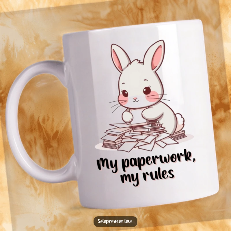 Funny mug featuring a determined rabbit meticulously organizing a small pile of papers, depicting office humor and a relatable struggle.