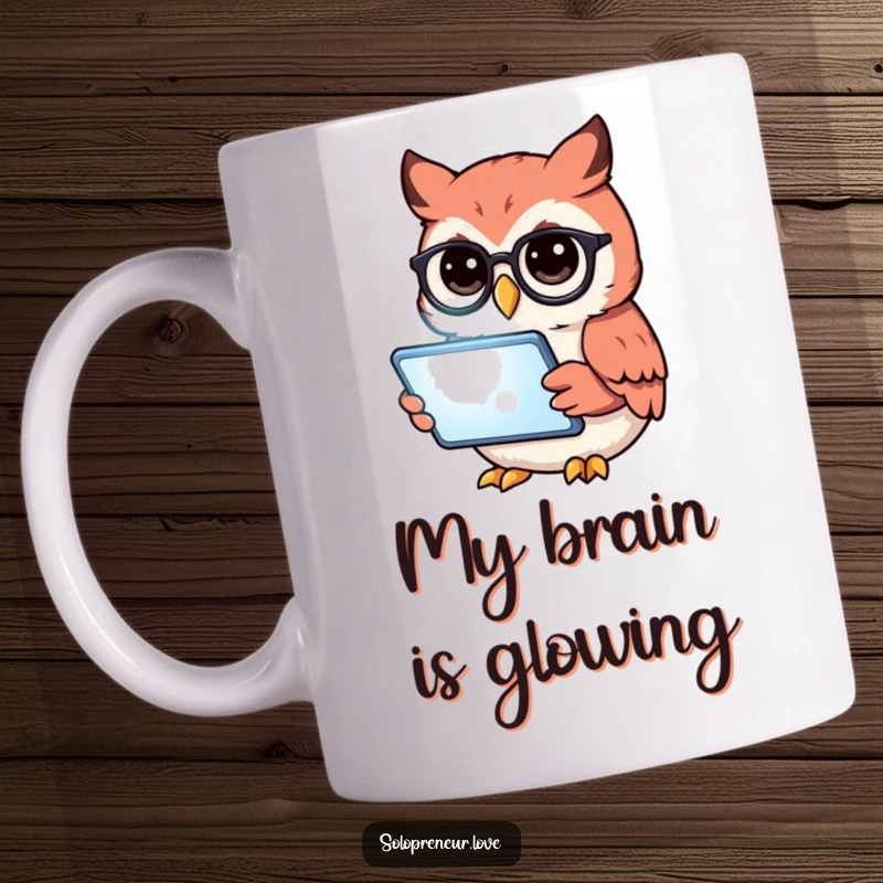 Funny owl wearing glasses, intensely reading a glowing tablet, on a creative mug, perfect for book lovers.