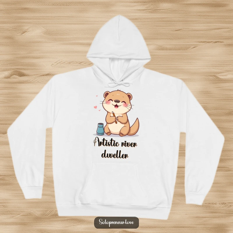 Funny hoodie showing a cheerful otter making digital art on a canvas, perfect for creative sessions and relaxation.