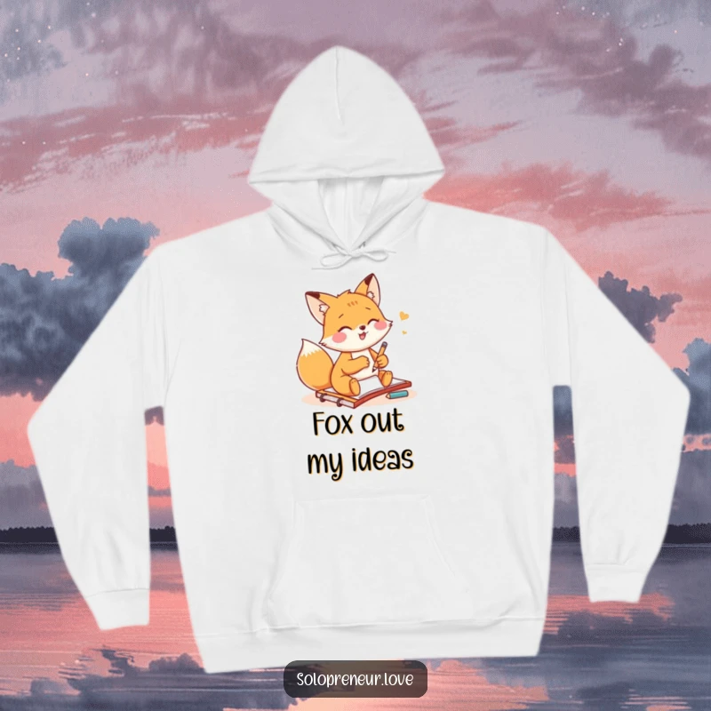 Funny fox artist hoodie with a small fox gleefully sketching on a notepad, providing warmth and artistic inspiration.