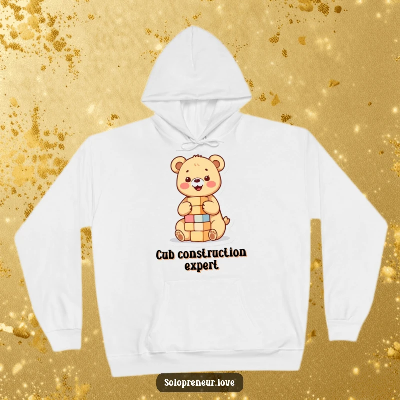 Funny hoodie showcasing a happy bear cub focused on building a small tower of blocks, offering comfort and a dose of playful charm.