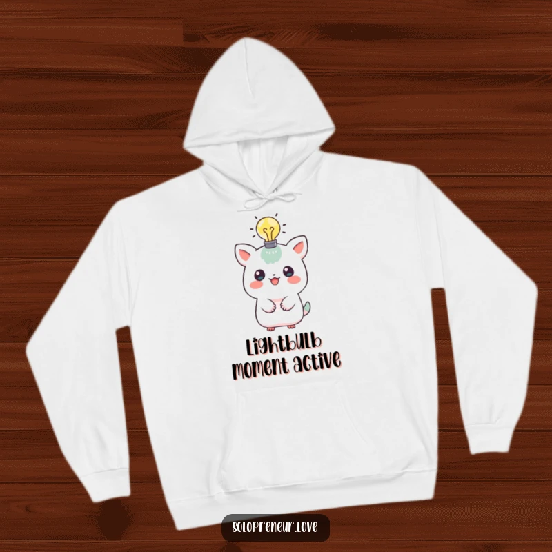 Funny hoodie depicting a playful creature with a lit lightbulb above its head, symbolizing creativity and a brilliant idea, perfect for cozy wear.