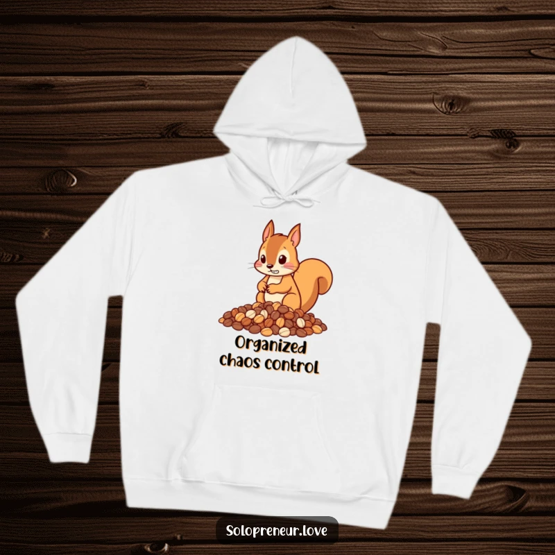 Funny hoodie featuring a determined squirrel character precisely arranging nuts into neat piles, emphasizing its diligent nature.