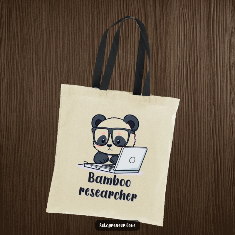 Funny tote bag showcasing a tiny panda with glasses working diligently on a laptop, perfect for carrying tech with humor.