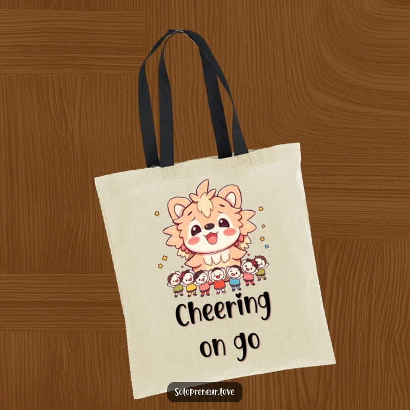 Funny tote bag featuring a cheerful creature surrounded by small, animated figures cheering, ideal for everyday use and spreading happiness.